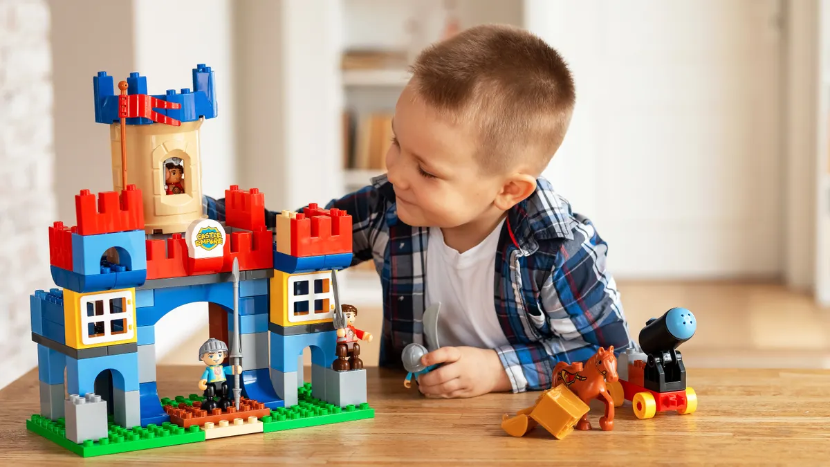 Child playing with a colorful block castle set